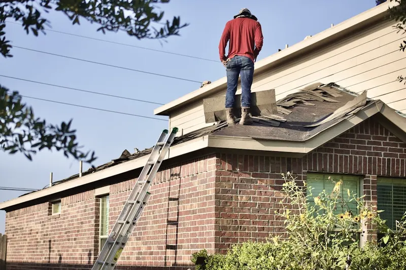 Professional roofer working on a residential roof in Miramar